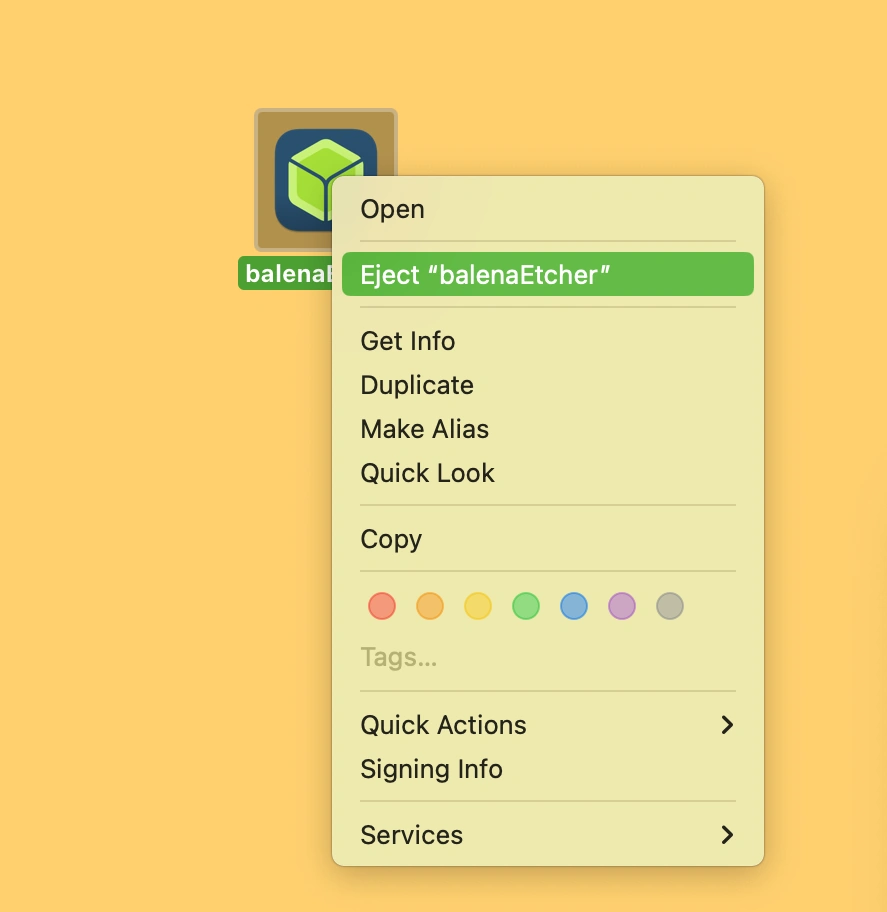 Screenshot of a desktop showing the balenaEtcher installation icon and a macOS menu with the option to Eject balenaEtcher.