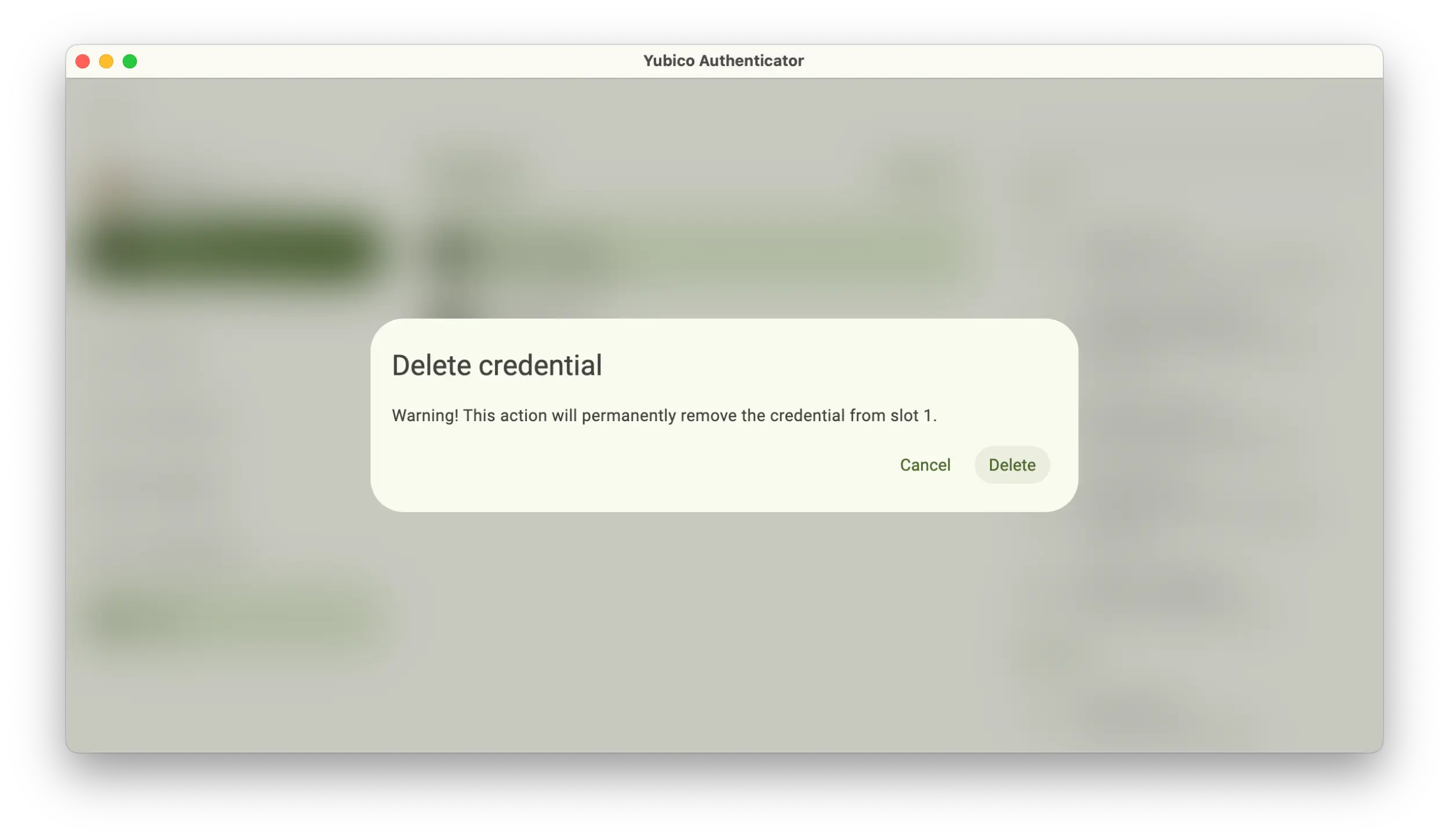 Screenshot of the Yubico Authenticator application showing a Delete credential popup.